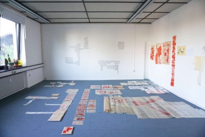 b o d y s c o r e s, studio view, process, 05/25, set of drawings and bodies - positioned on the floor, with wall drawing (position overlaps with three characters/bodies)